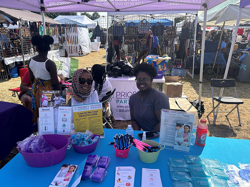 Priority Partners team members representing a table at the Kunte Kinte festival